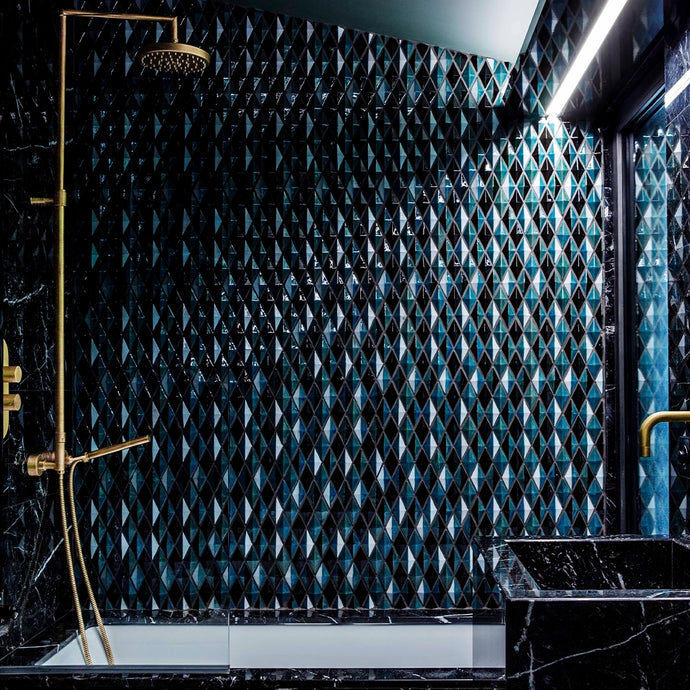 Bathroom with marble bath, golden shower and various blue Botteganove Diamantino tiles