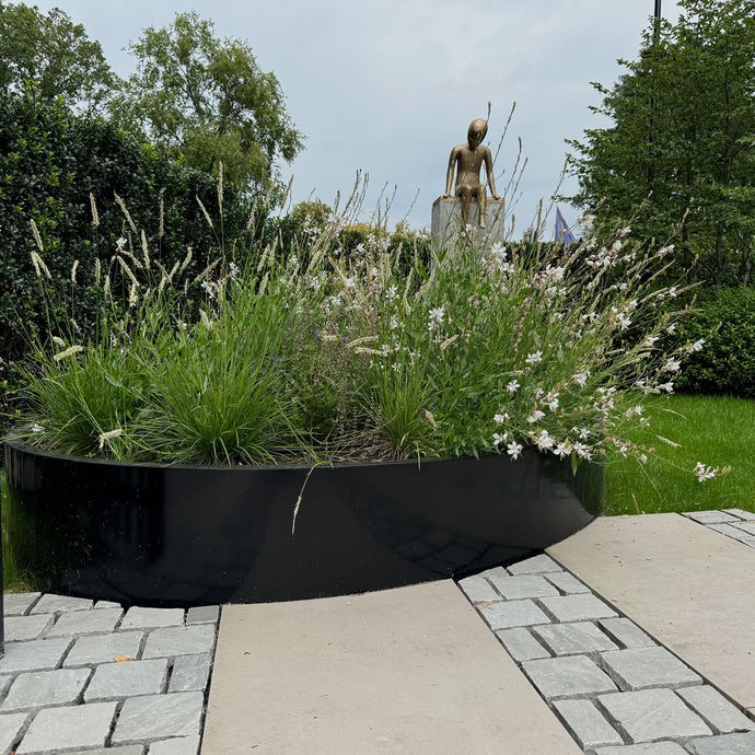 Black steel planters in the front garden of Villa Arte, filled with lovely plants